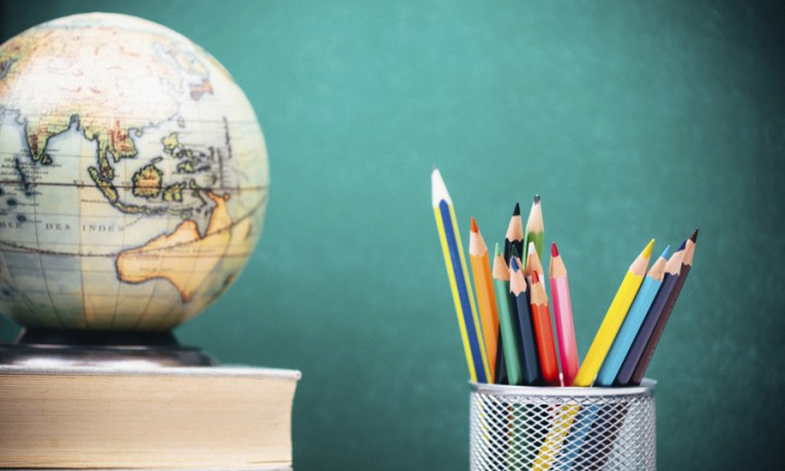 Crayons against the blackboard in the classroom
